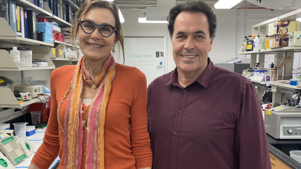 Lynne Maquat and Christoph Pröschel standing in a University of Rochester laboratory.