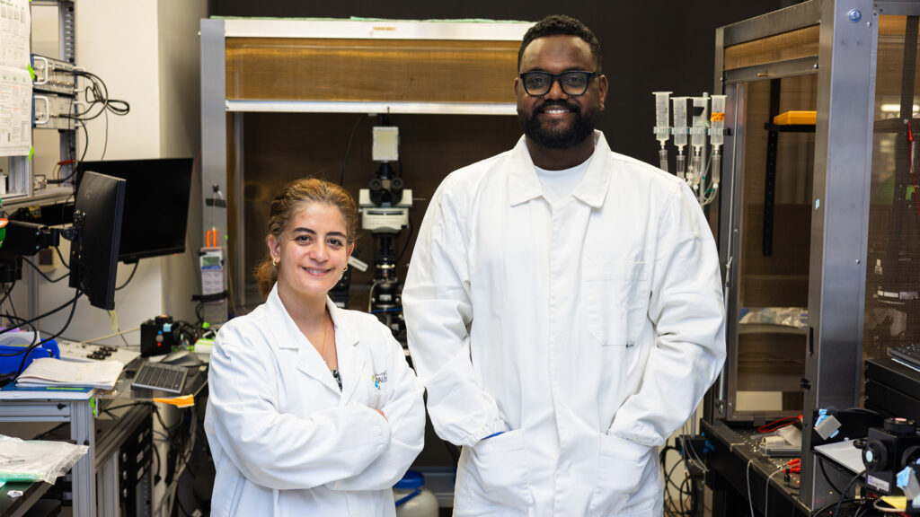 Leena Ibrahim, PhD, and Deyl S. Djama, PhD, standing in their laboratory at KAUST.