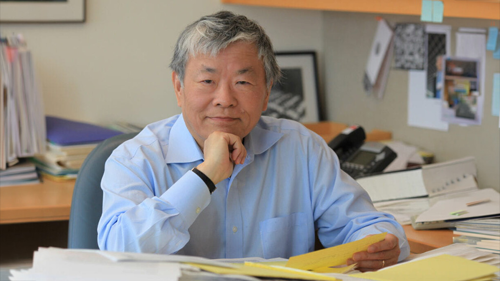 Susumu Tonegawa, PhD, seated at his desk